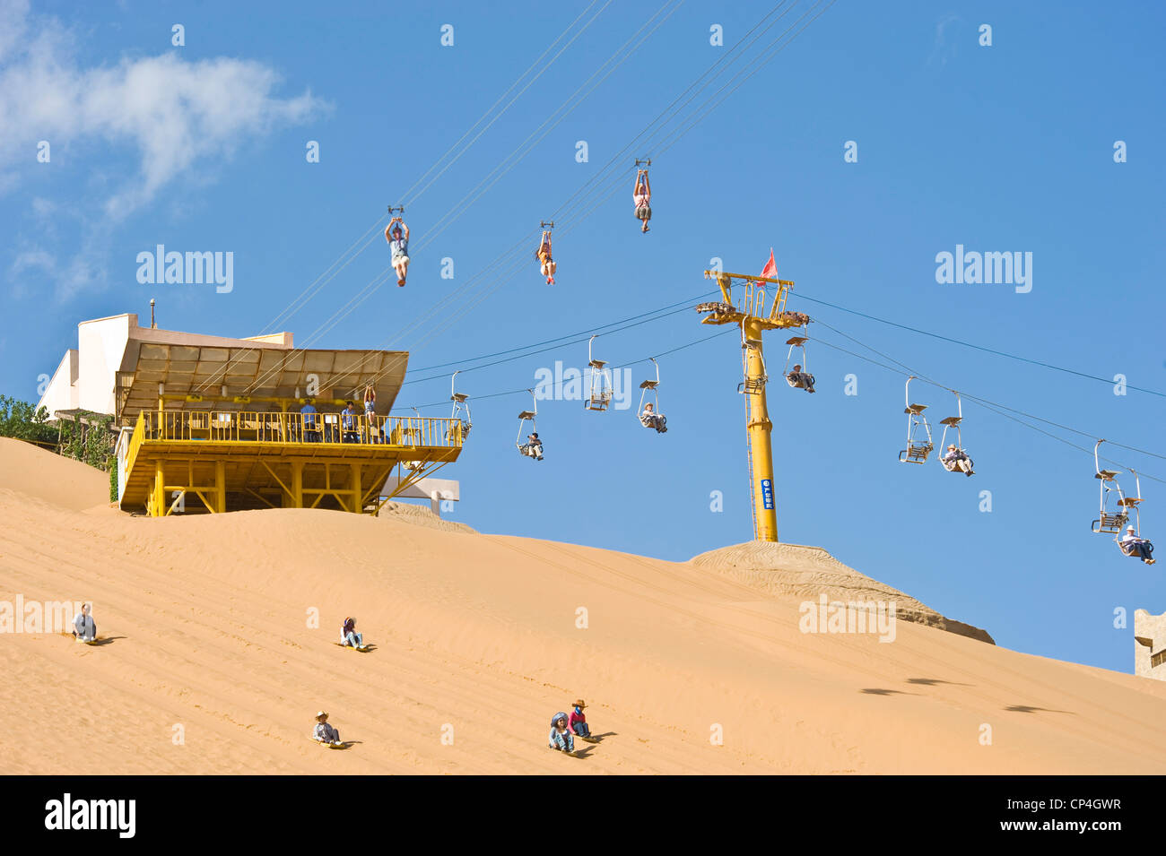 Tourists at the Shapatou Theme Park enjoy sand boarding and the zip wire rides. Stock Photo