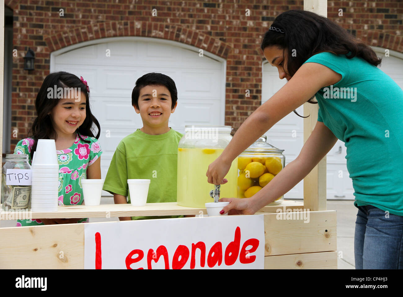 Children selling lemonade in front of their home Stock Photo Alamy