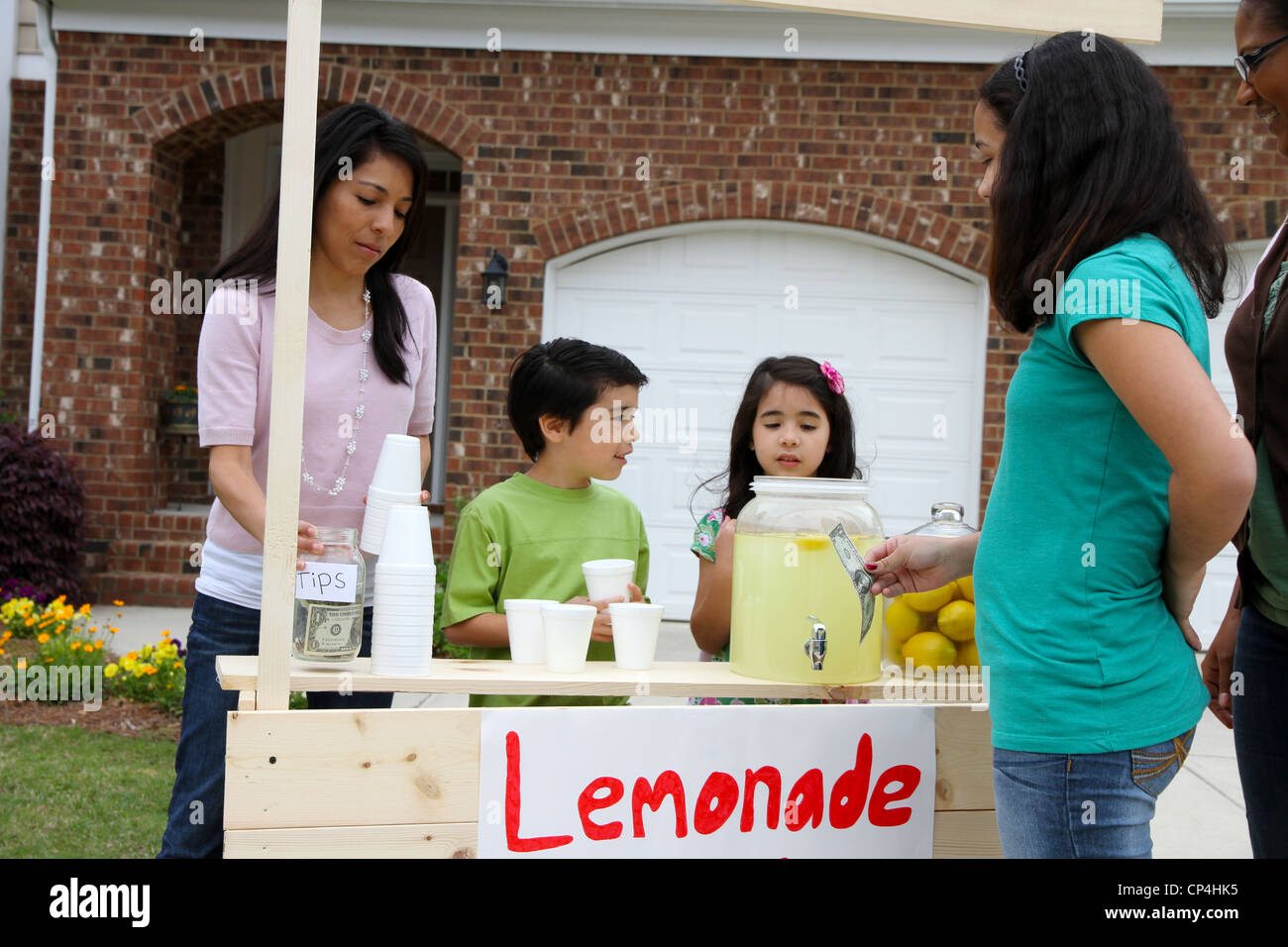 Children selling lemonade in front of their home Stock Photo Alamy
