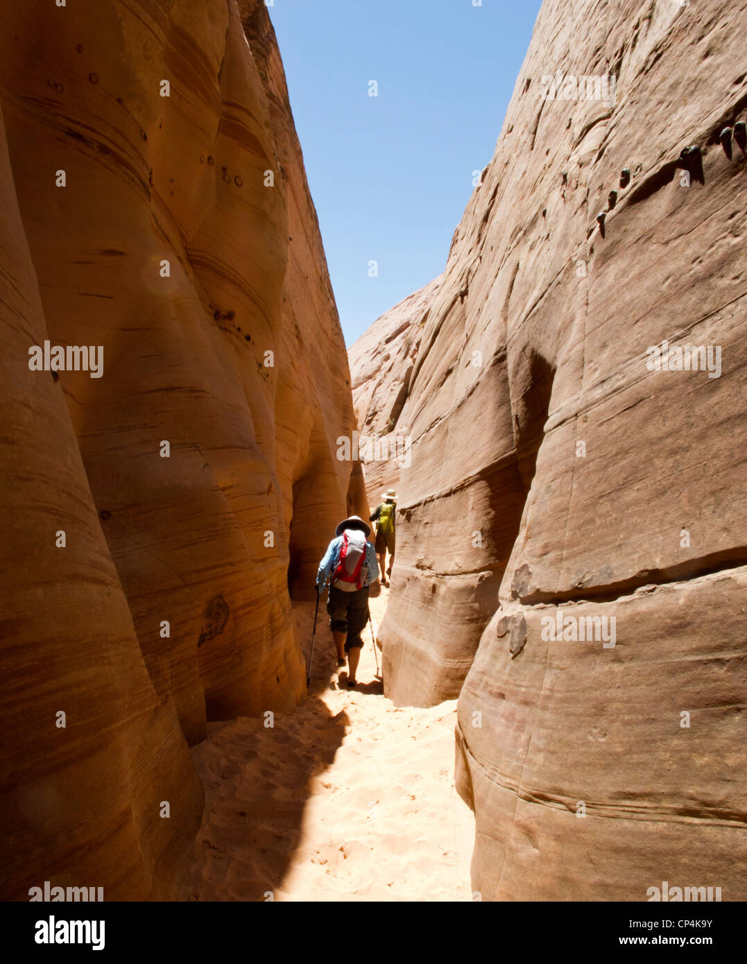 Hikers in a slot canyon in Grand Staircase-Escalante National Monument, Utah Stock Photo