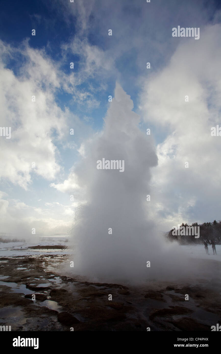 Strokkur fountain geyser exploding into the air and backlit by the sun