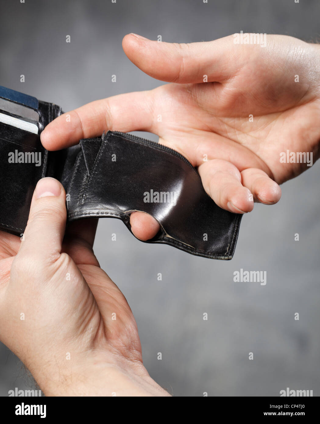 Man showing a hole in the coin pocket of his wallet Stock Photo Alamy