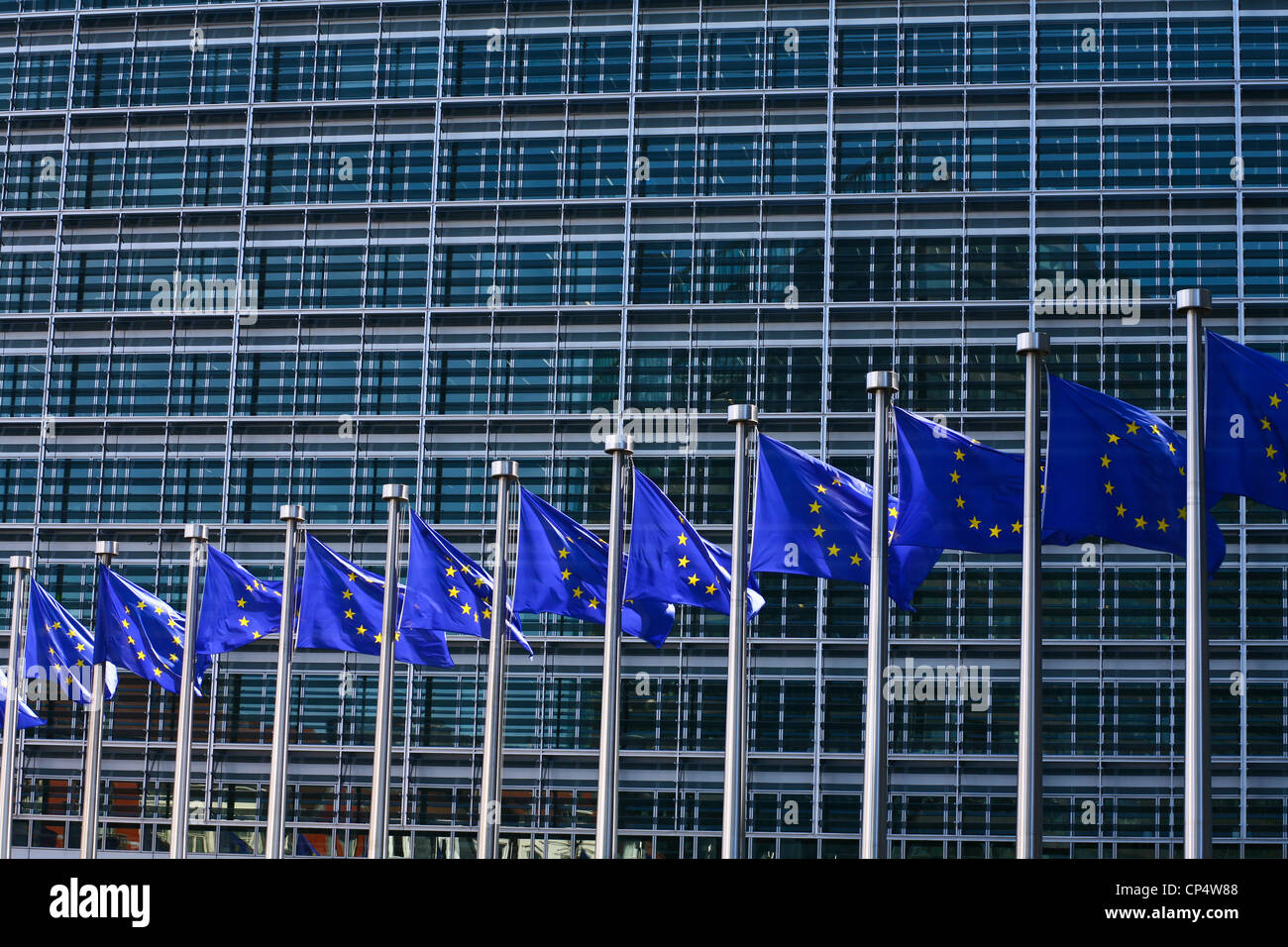 EU flags fronting the Berlaymont - an office building in Brussels,  that houses the headquarters of the European Commission Stock Photo