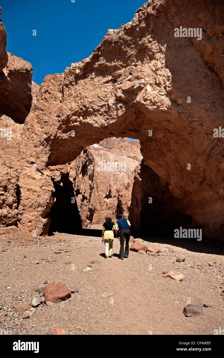 People Exploring Rocks Natural Bridge,man and woman hiker exploring rock formation Stock Photo ...