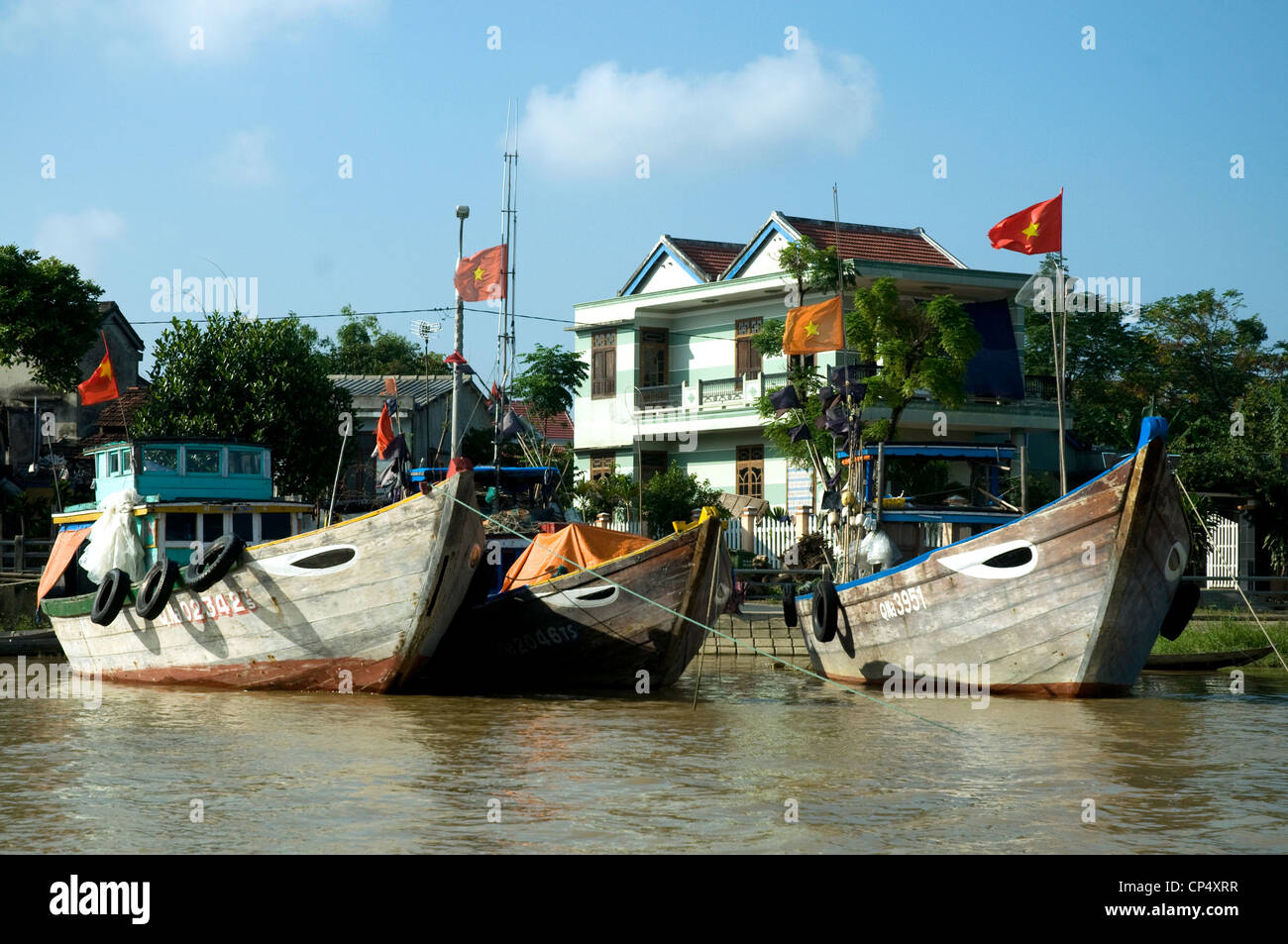 In Vietnam's Hoi An, an historic trading port, modern fishing boats are moored along the Thu Bon river Stock Photo