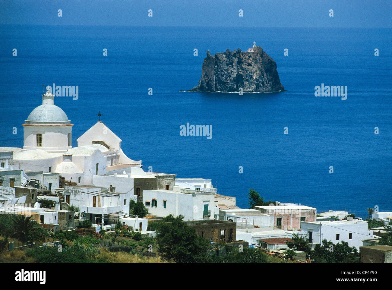 Sicily Aeolian Islands Stromboli Island View of the town of San Vincenzo (Me) with the church in the background Strombolicchio. Stock Photo