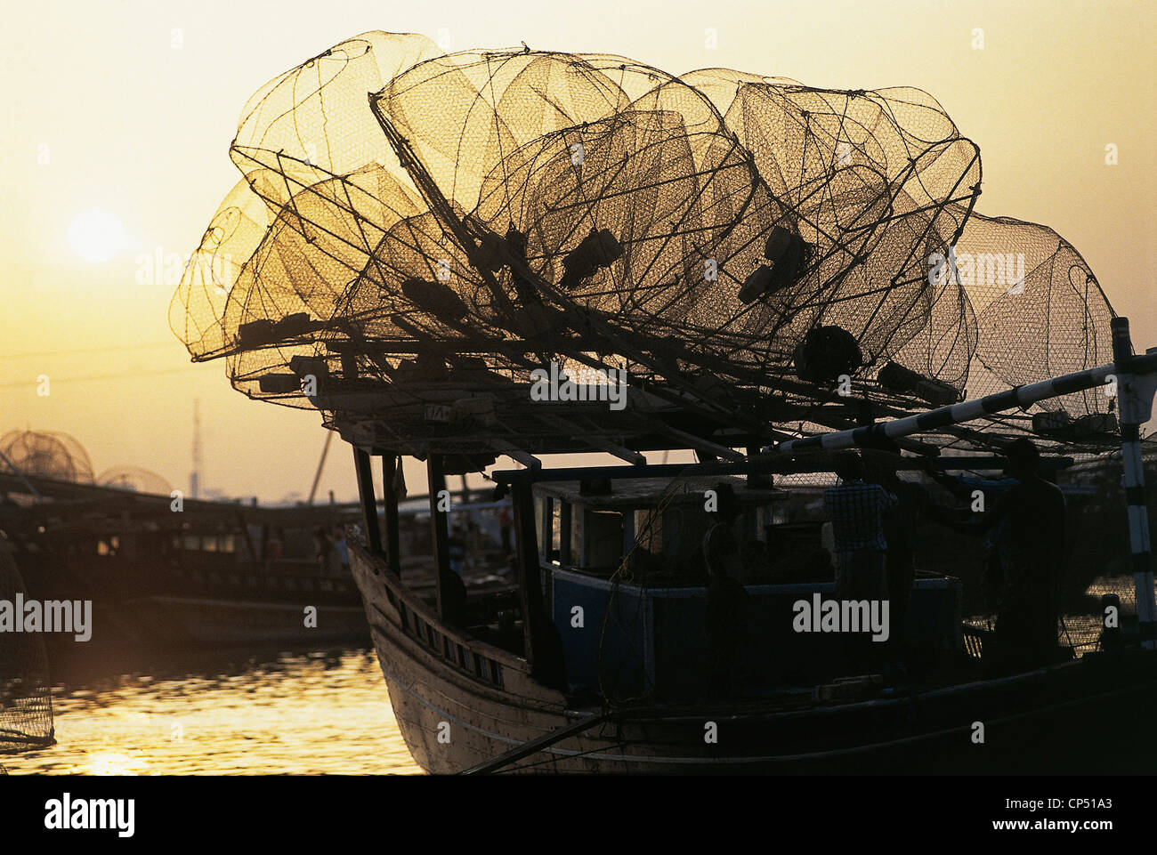 Qatar Doha (AdDawhah). Fishing boat with nets at sunset Stock Photo
