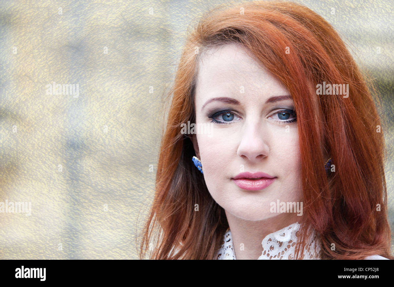 Beautiful red-headed woman with a grunge textured background Stock Photo