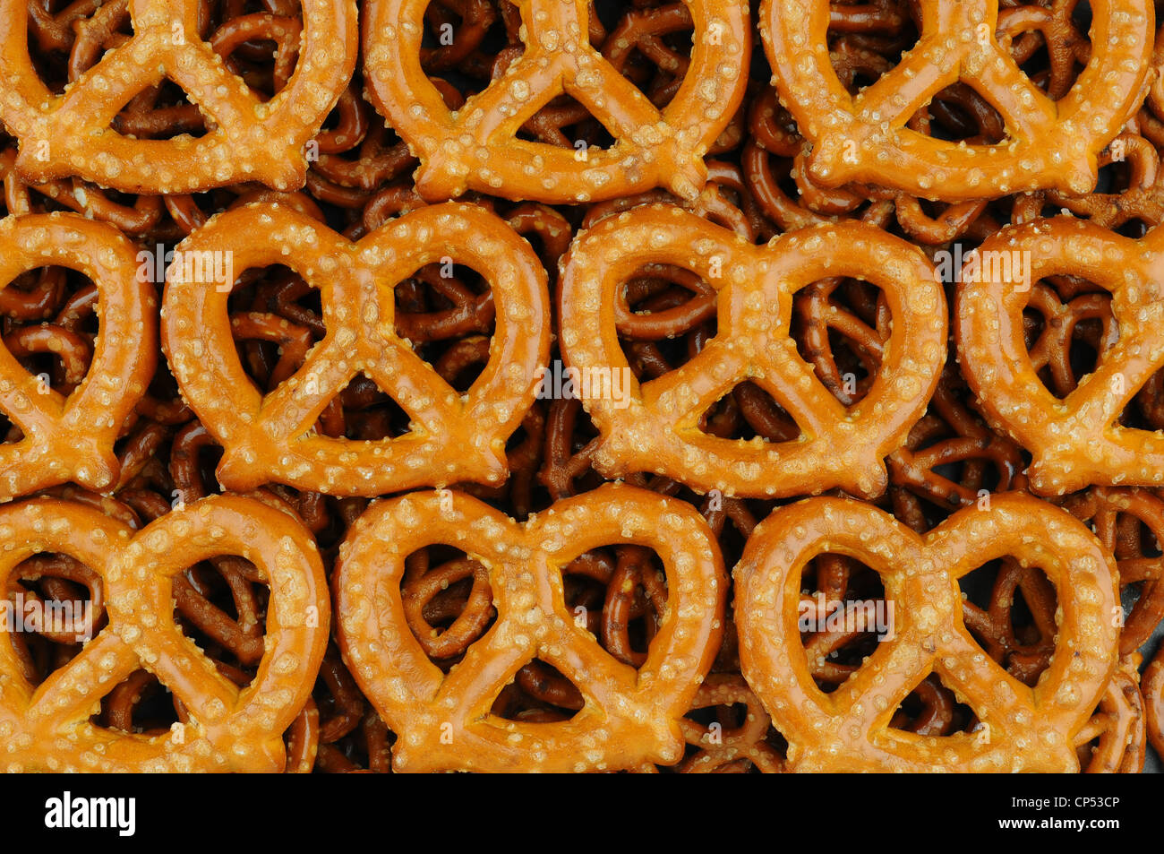 A Closeup of Large Sourdough Pretzels on a bed of smaller pretzels. Stock Photo