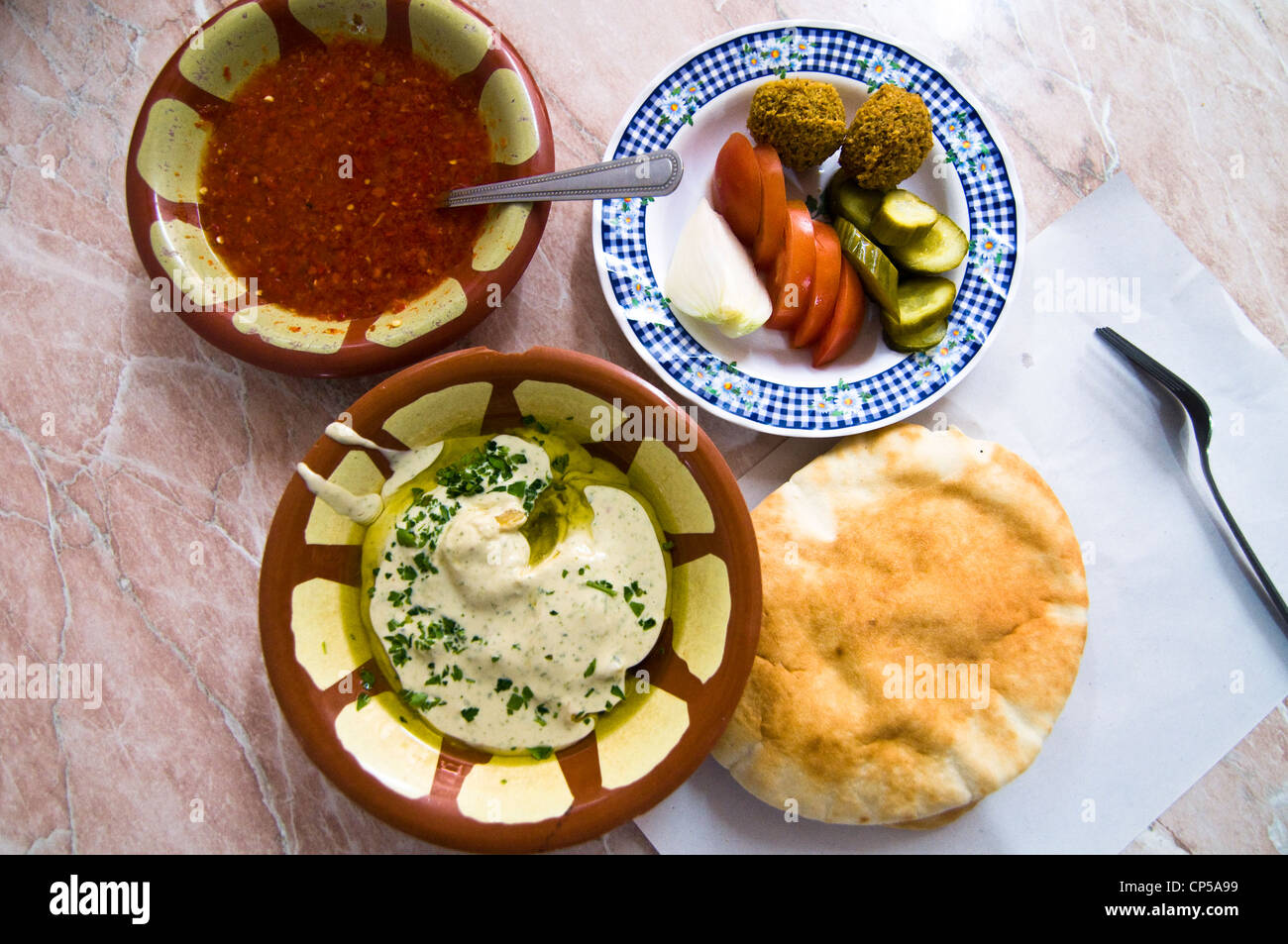 Hummus Masabacha served with pita bread, veggies and Falafel balls