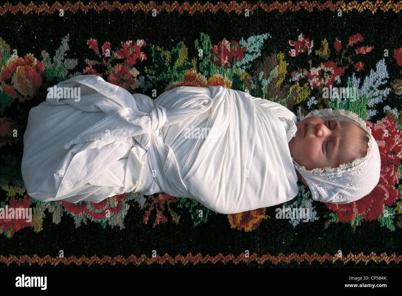 baby in swaddling clothes