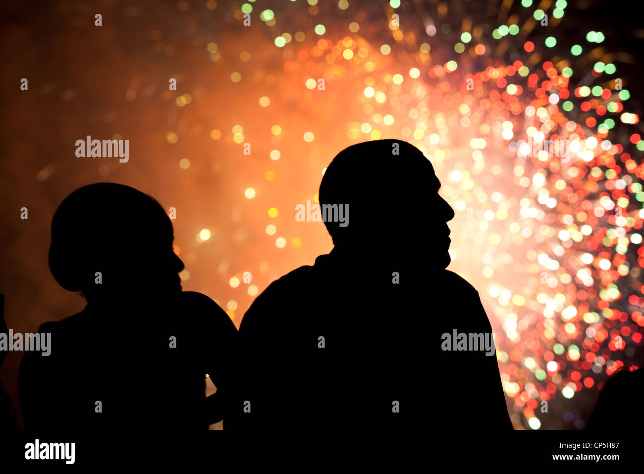President Barack Obama and First Lady Michelle Obama watch fireworks from the roof of the White House, July 4, 2011. Stock Photo