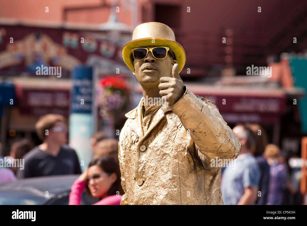 Gold man street performer on busy street - San Francisco, California USA Stock Photo