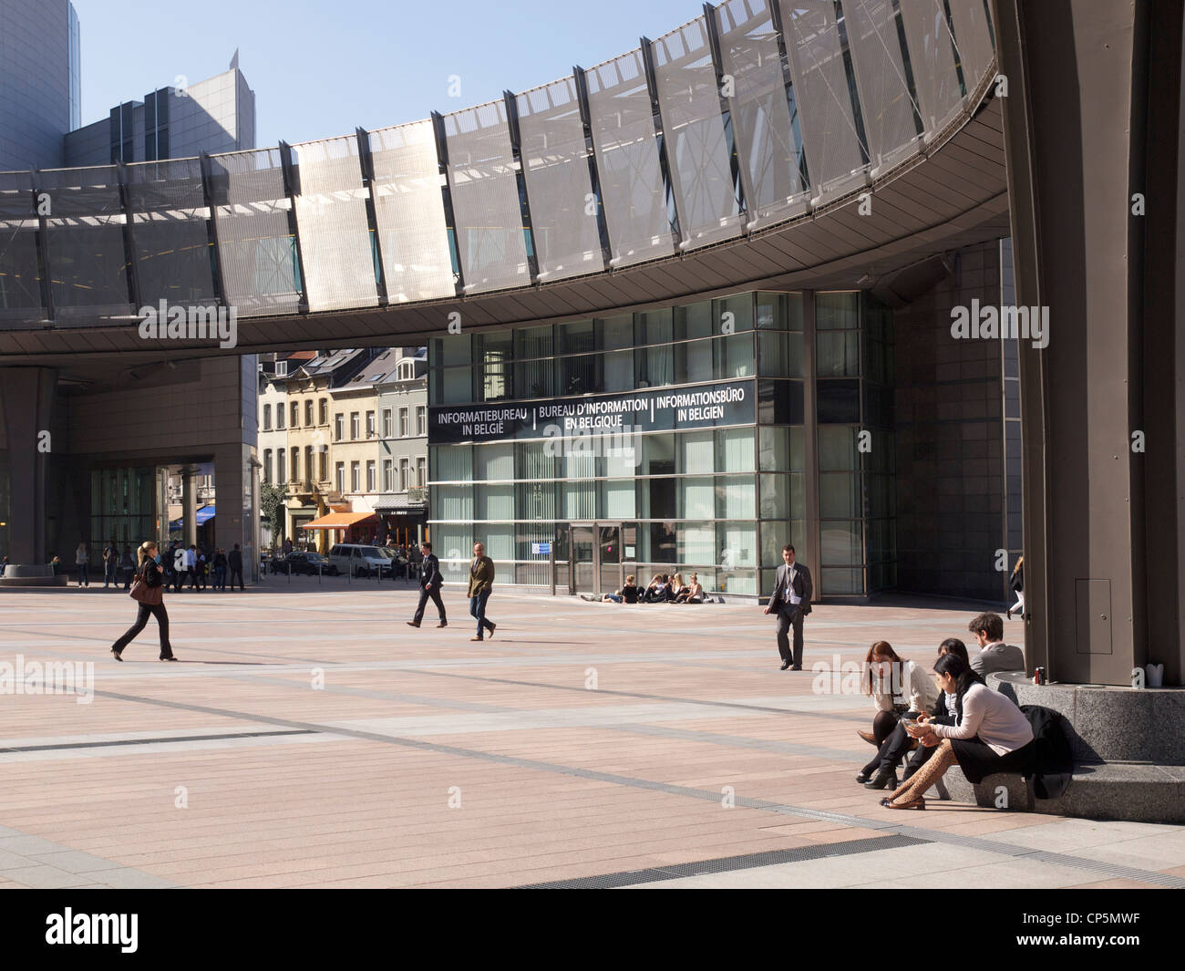People sitting in the sun at lunchtime, European Parliament buildings, Brussels, Belgium Stock Photo