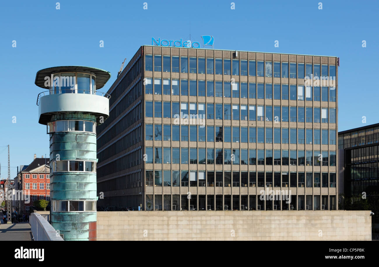 The Danish headquarters of the Nordea Bank on Strandgade, Copenhagen, Denmark. Left, one of  the funtionalistic towers of Knippelsbro bridge. Stock Photo