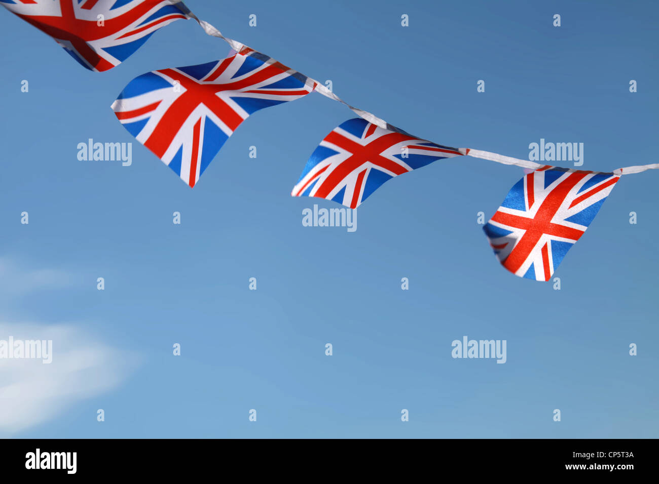 Jubilee United kingdom flags blowing in wind with blue sky background Stock Photo