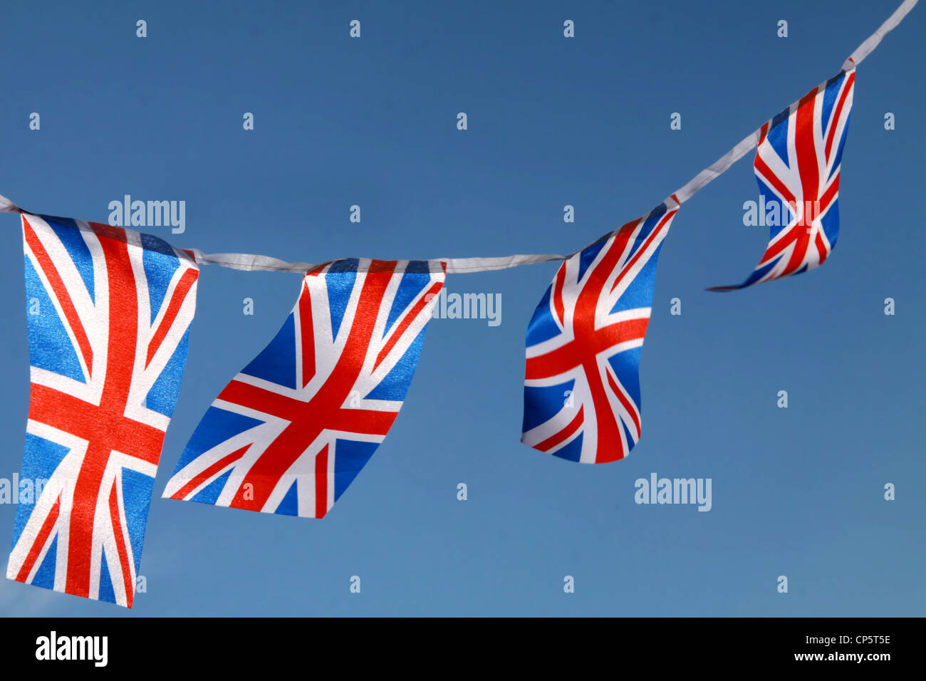 Jubilee United kingdom flags blowing in wind with blue sky in landscape horizontal format Stock Photo