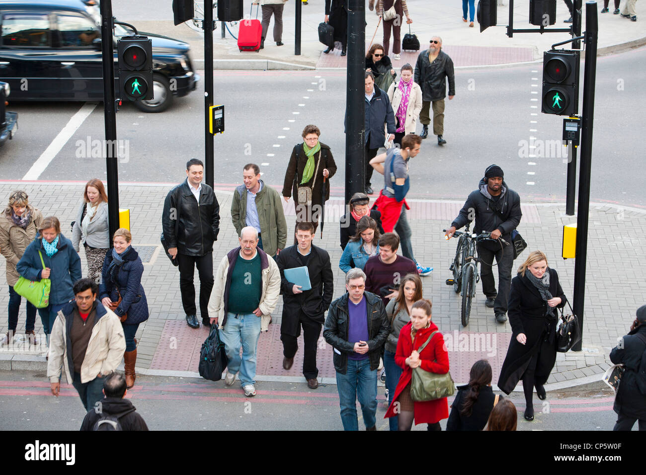 Pedestrians at a crossing in Kings Cross, London, UK. Stock Photo