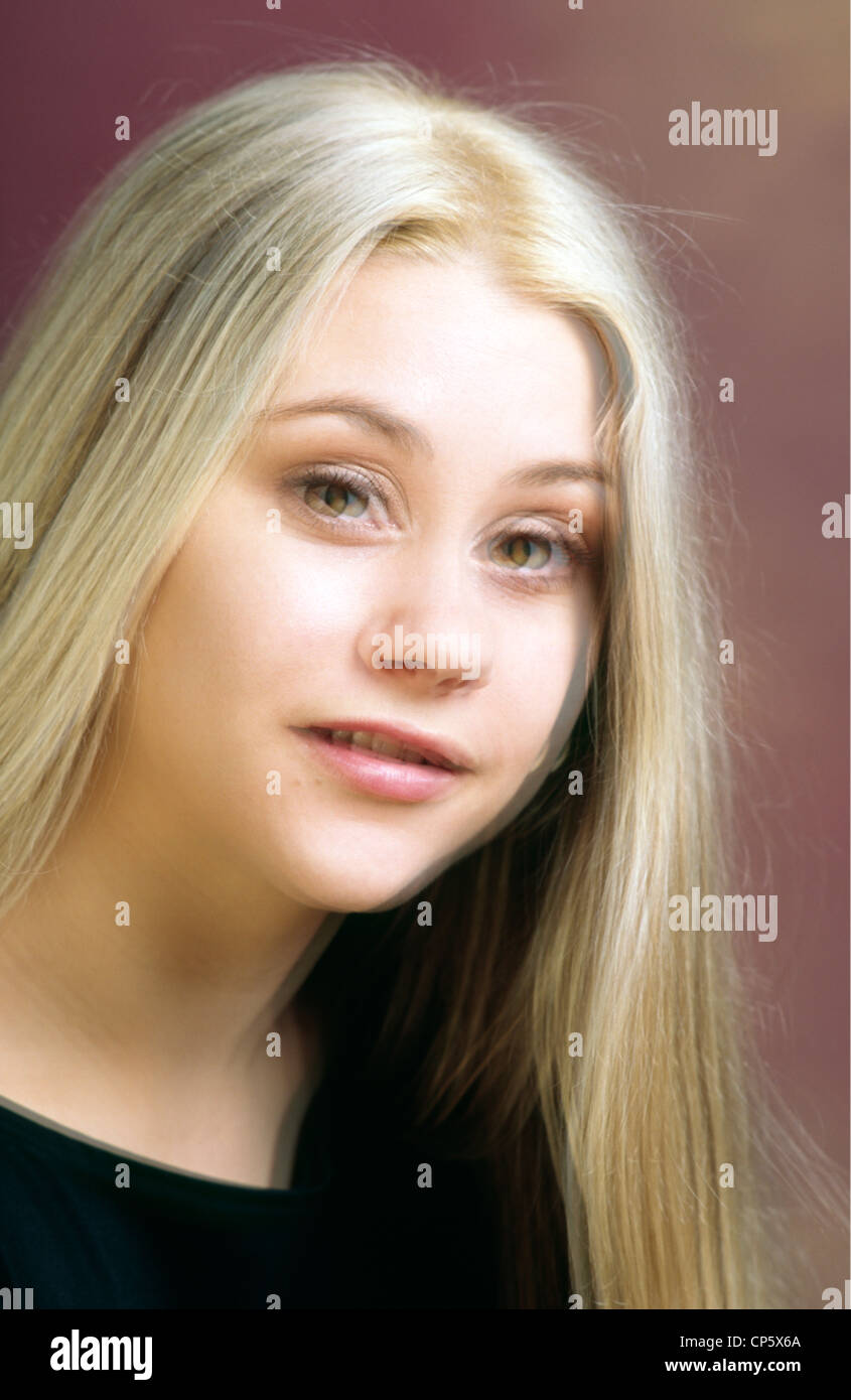 Double vision example picture of a pretty girl with long blond hair and green hazel eyes Head and shoulders Vertical format Stock Photo