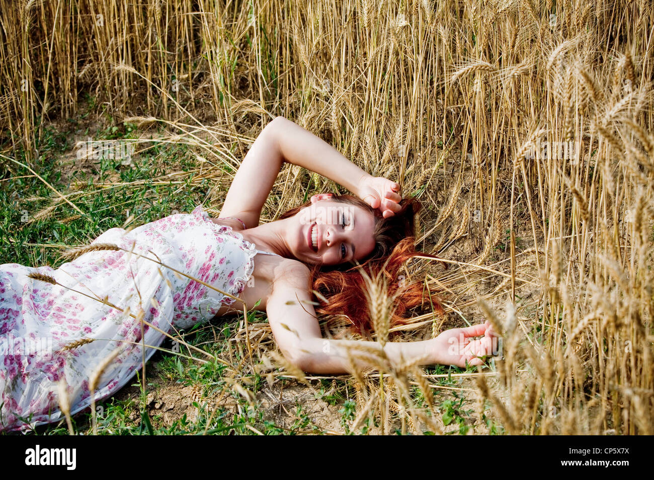 woman lying in a field of wheat Stock Photo - Alamy