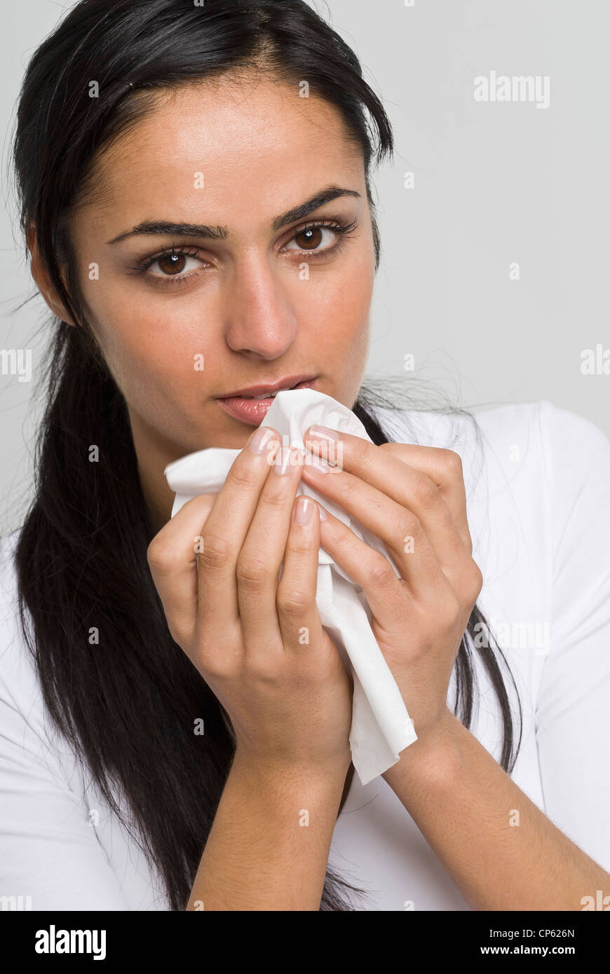 Young woman using handkerchief, portrait Stock Photo Alamy