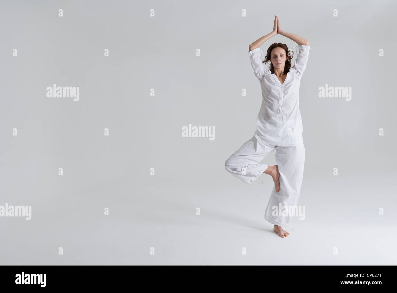 Mid adult woman doing tree pose Stock Photo - Alamy