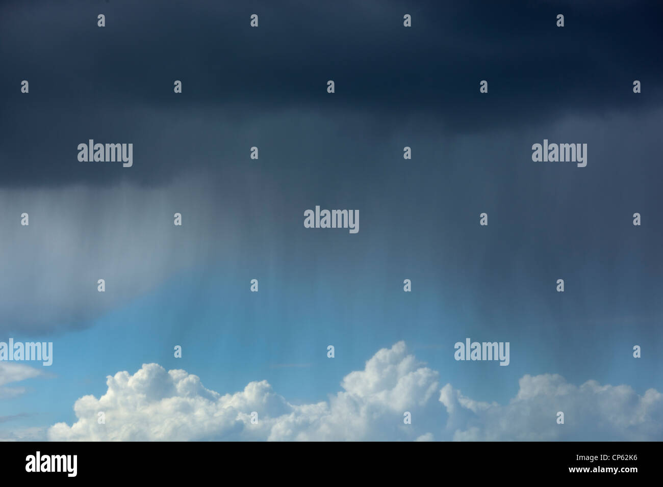 rain falling from dark clouds on showery day Stock Photo