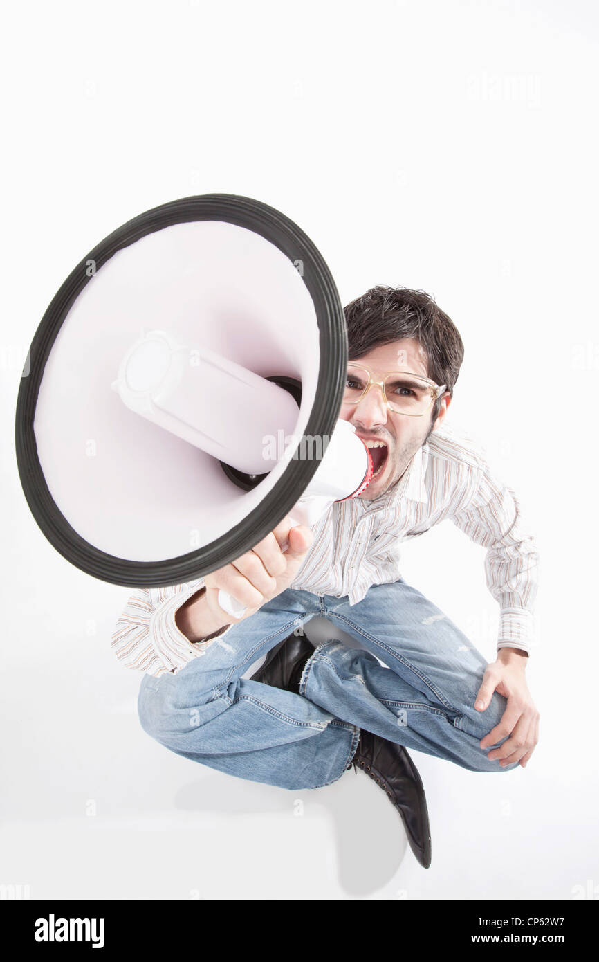 Young man with crazy glasses and megaphone, portrait Stock Photo