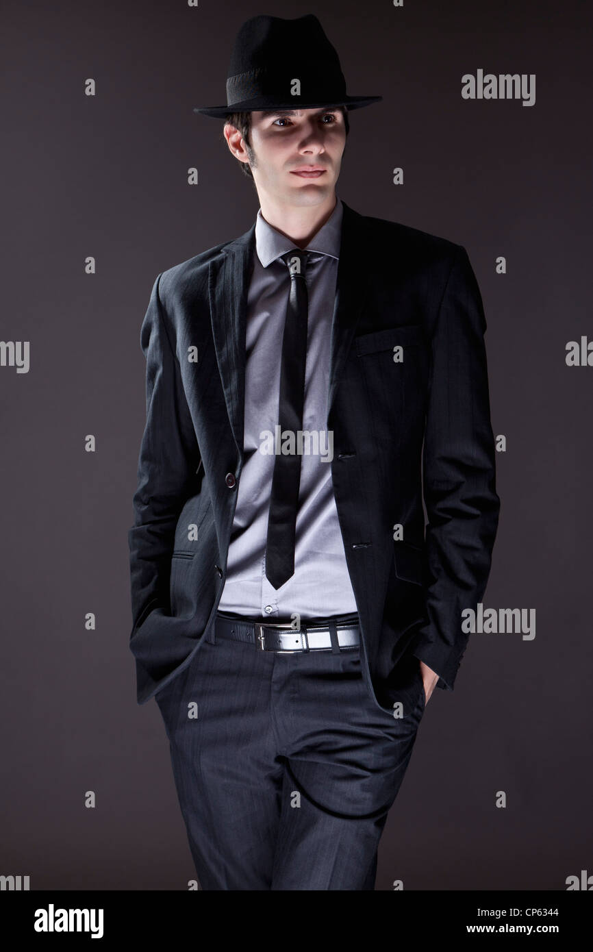 Young man in black suit with hat hi-res stock photography and images - Alamy