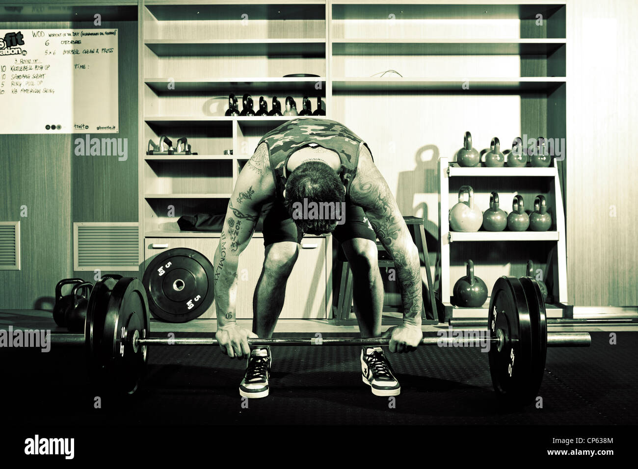 Man with tattoos lifting weights during a crossfit training at the gym Stock Photo - Alamy Man with tattoos lifting weights during a crossfit training at the gym Stock Photo - Alamy