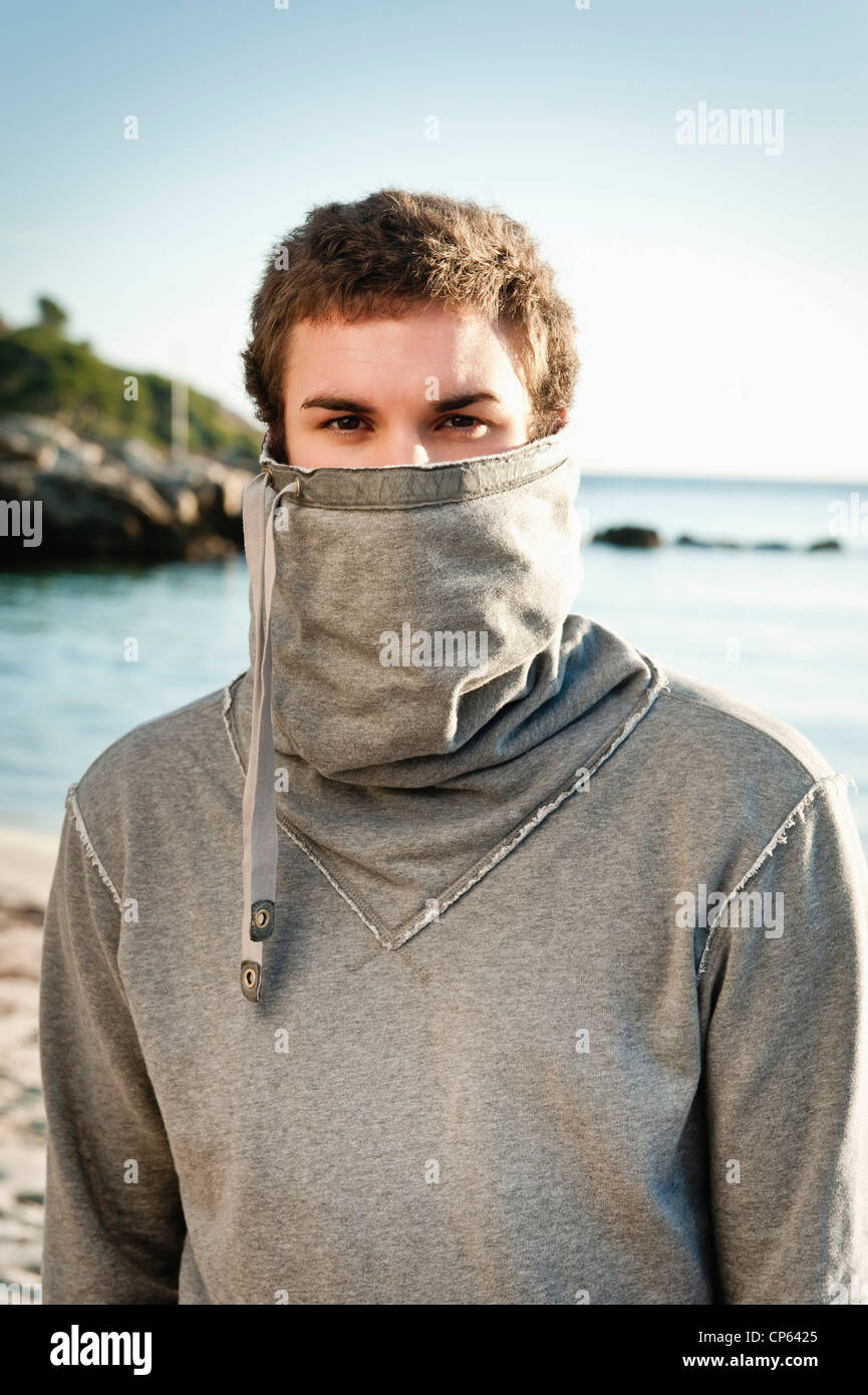 Spain, Mallorca, Young man in sweatshirt on beach, portrait Stock Photo