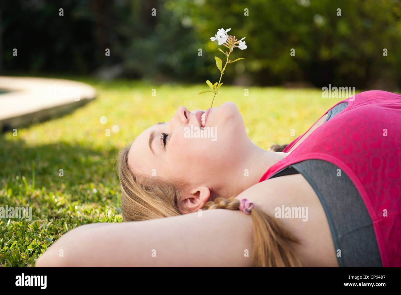 Spain, Mallorca, Teenage girl lying in grass, smiling Stock Photo