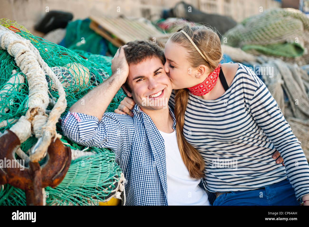 Spain, Mallorca, Couple at harbour with fishing nets, smiling Stock Photo