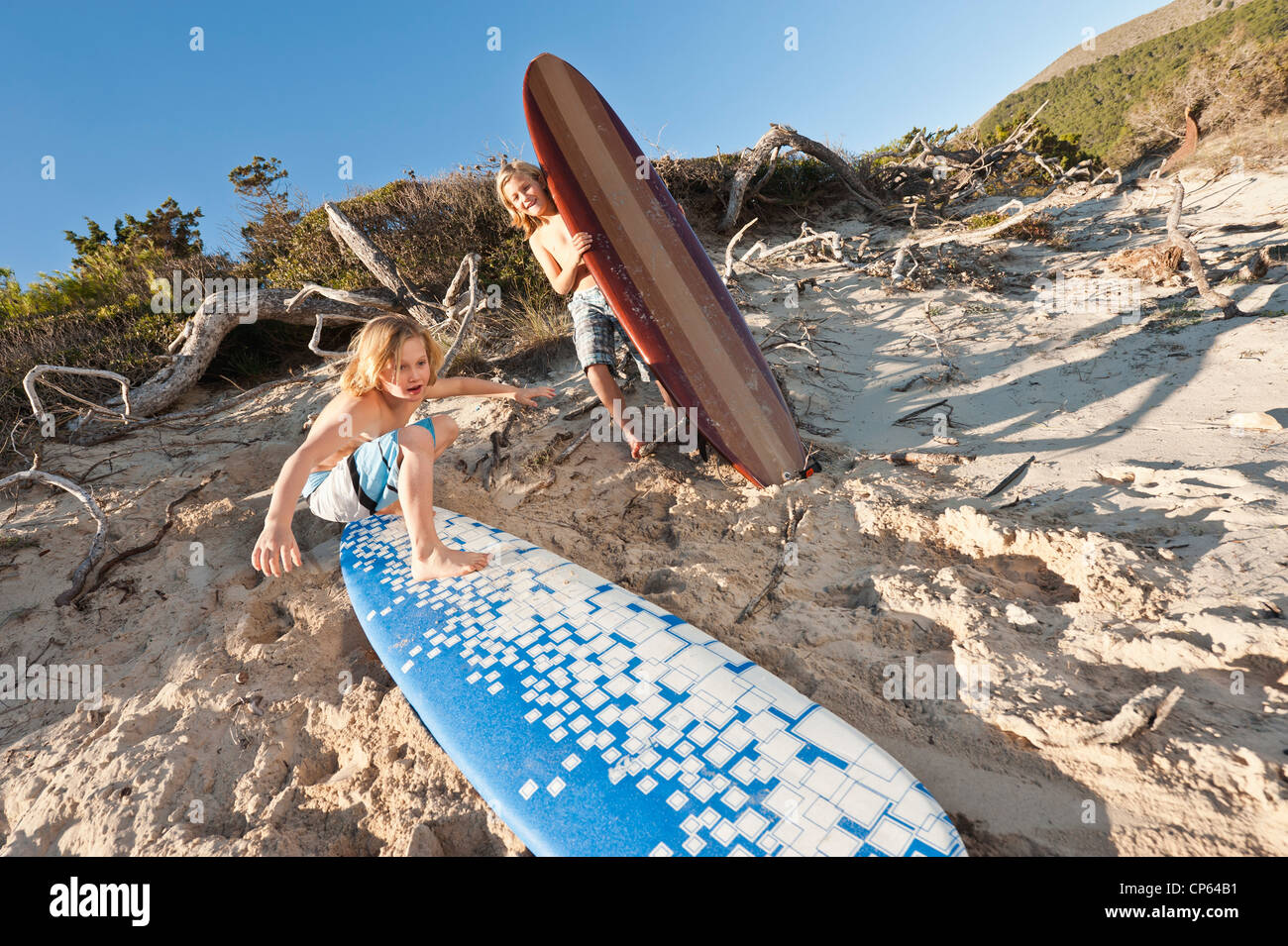 Spain, Mallorca, Children with surfboard on beach Stock Photo
