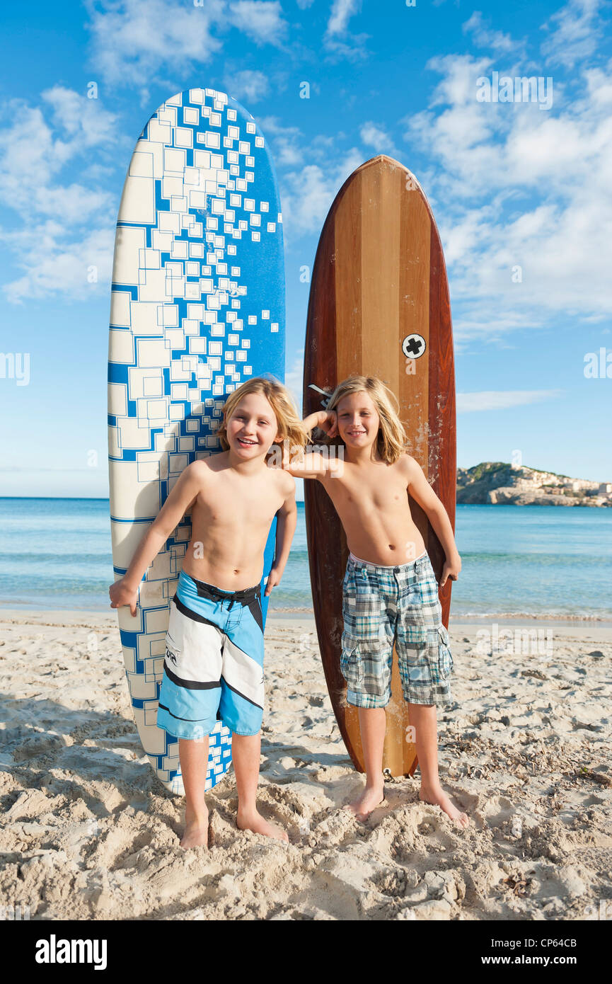 Spain, Mallorca, Children with surfboard on beach Stock Photo