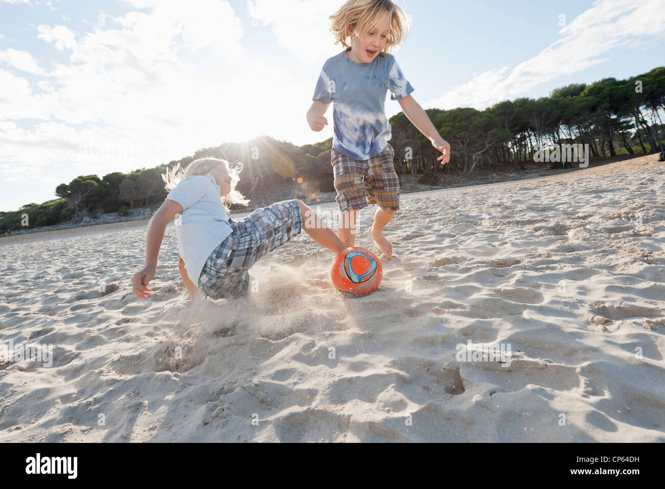 Spain, Mallorca, Children playing soccer on beach Stock Photo