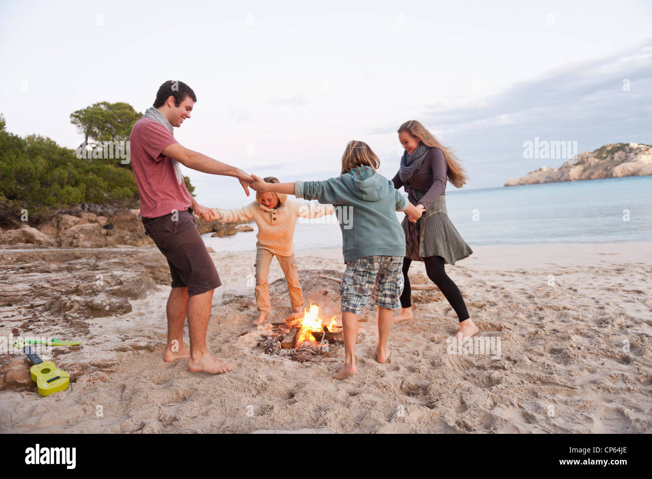 Spain, Mallorca, Friends dancing at camp fire on beach Stock Photo