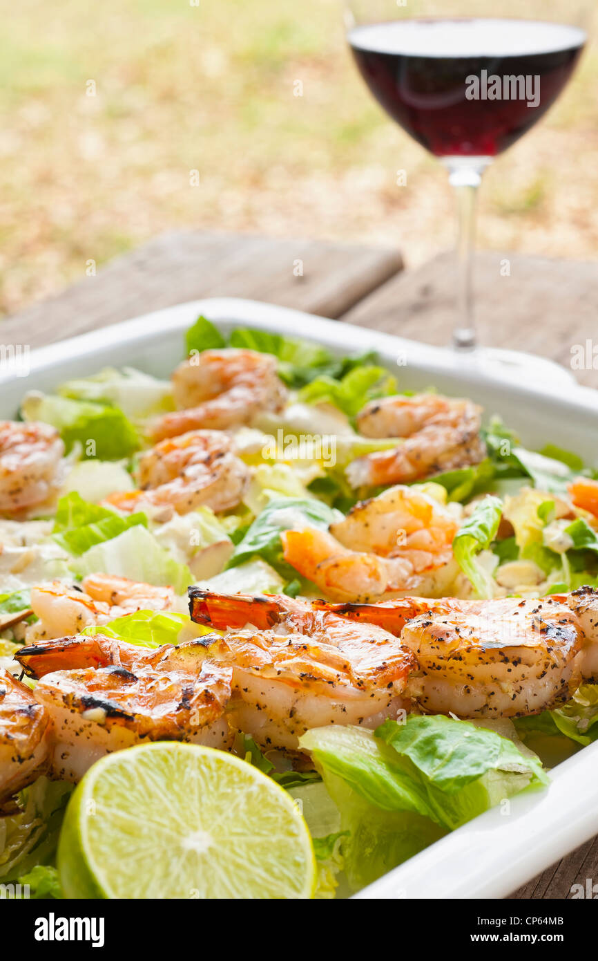 Healthy diet - Fresh field salad with grilled shrimps, lemon and red wine Stock Photo