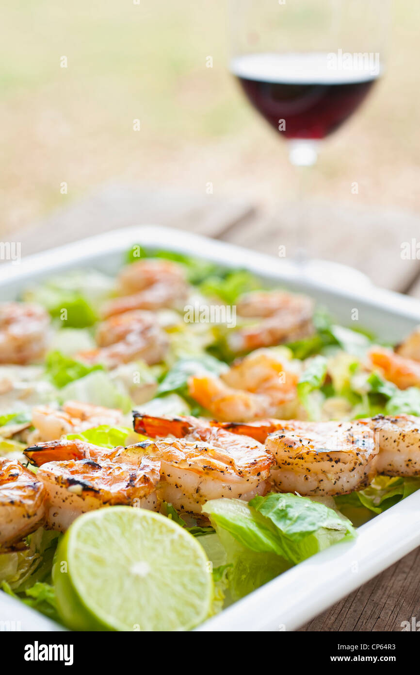 Healthy diet - Fresh field salad with grilled shrimps, lemon and red wine Stock Photo