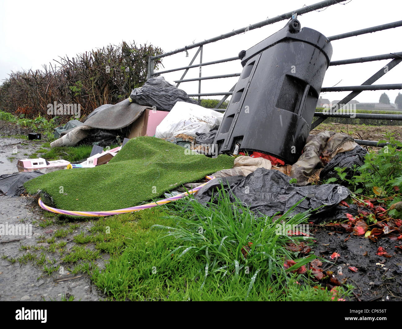 Fly tipping tip in gateway in UK countryside Stock Photo