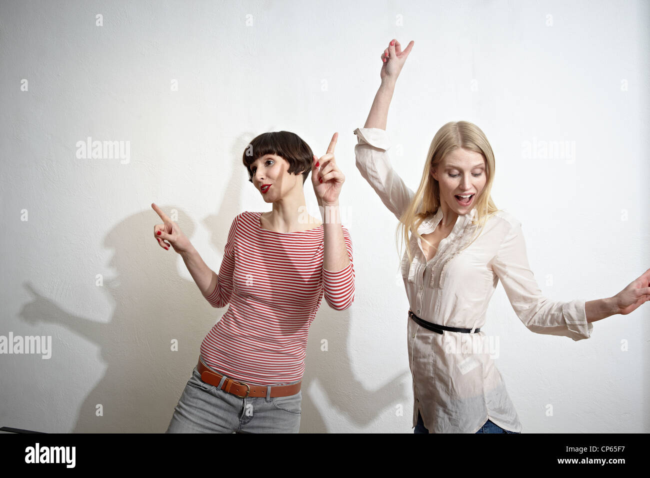 Germany, Cologne, Young women having fun, smiling Stock Photo