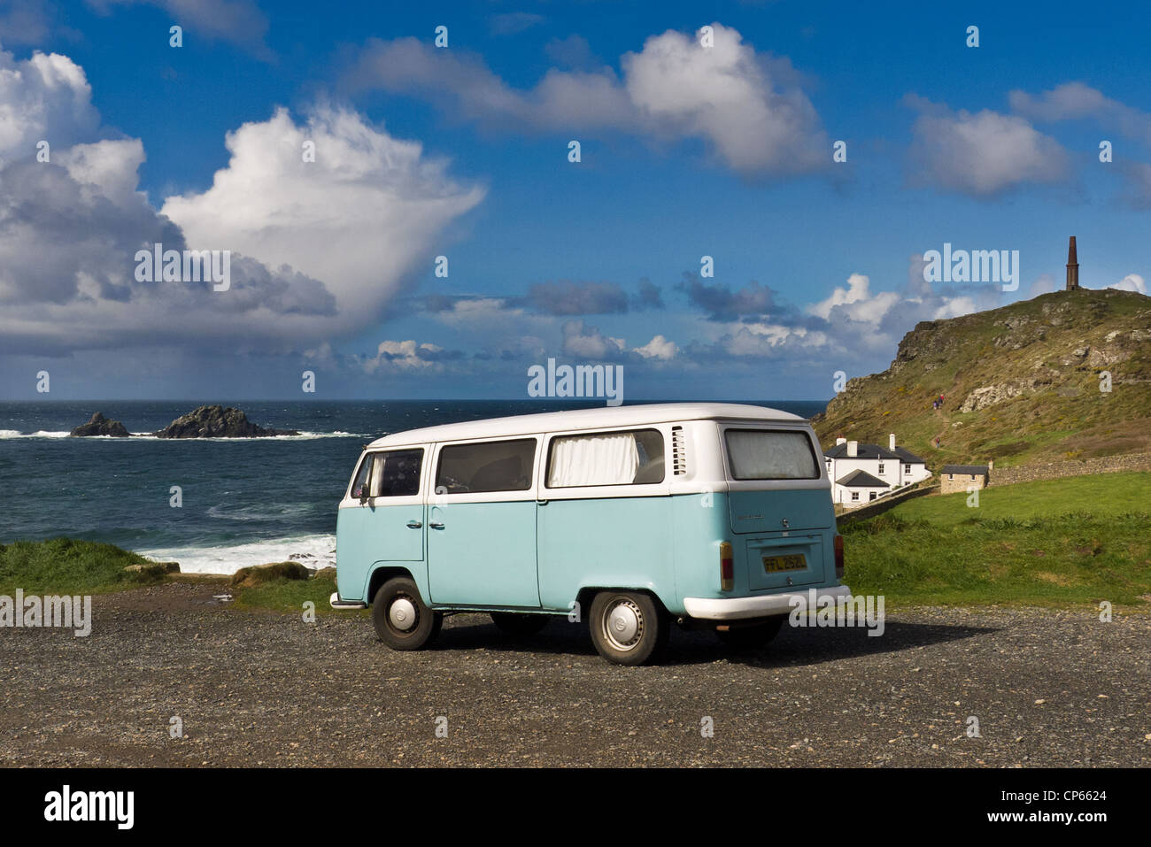 Camper van seen at Cape Cornwall in West Penwith,Cornwall. The rocky islands in the sea are known as the Brisons. Stock Photo