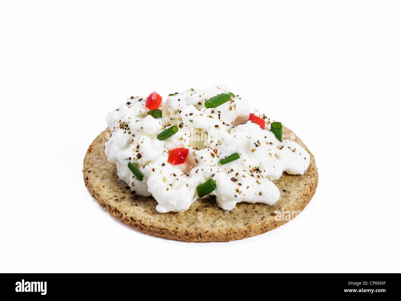 Oatcake topped with cottage cheese garnished with chives,red capsicum and ground pepper Stock Photo