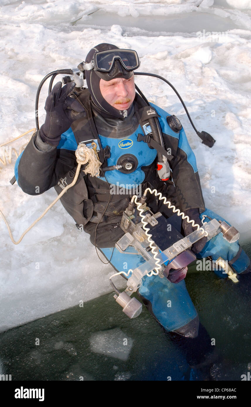 Diver, subglacial diving, ice diving, in the frozen Black Sea, a rare