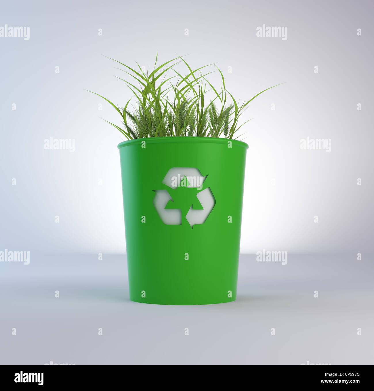 A recycling trash bin with growing grass Stock Photo