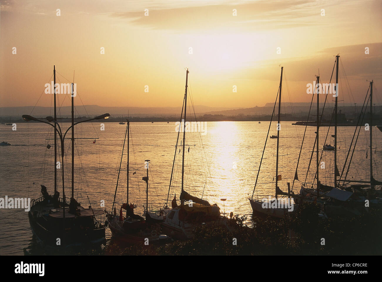 sicily-siracusa-ortigia-island-boats-on-the-sea-sunset-stock