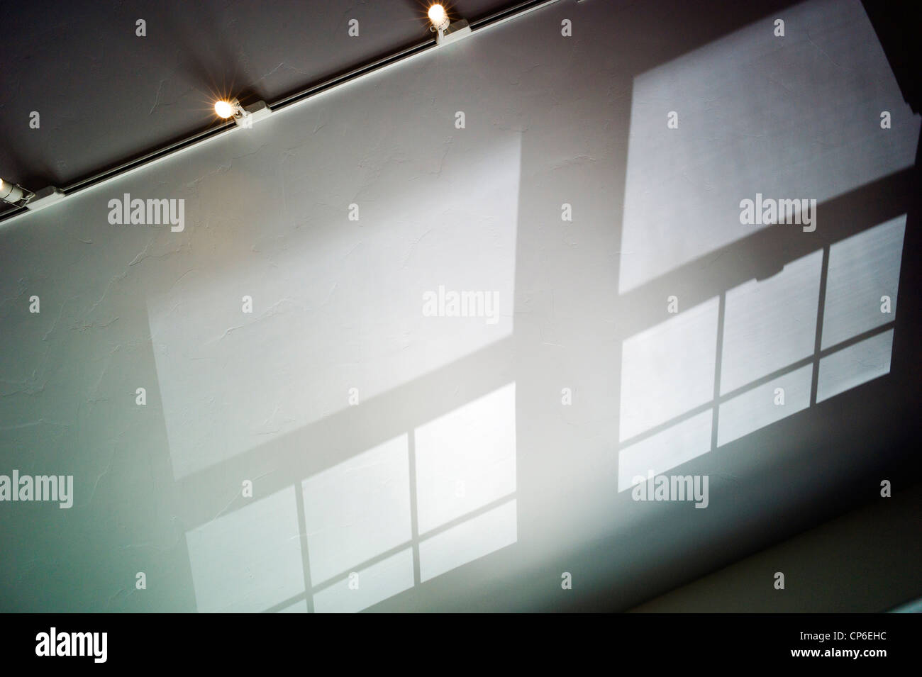 Reflections, shadows and window patterns cast on the vaulted ceiling of a home office. Stock Photo