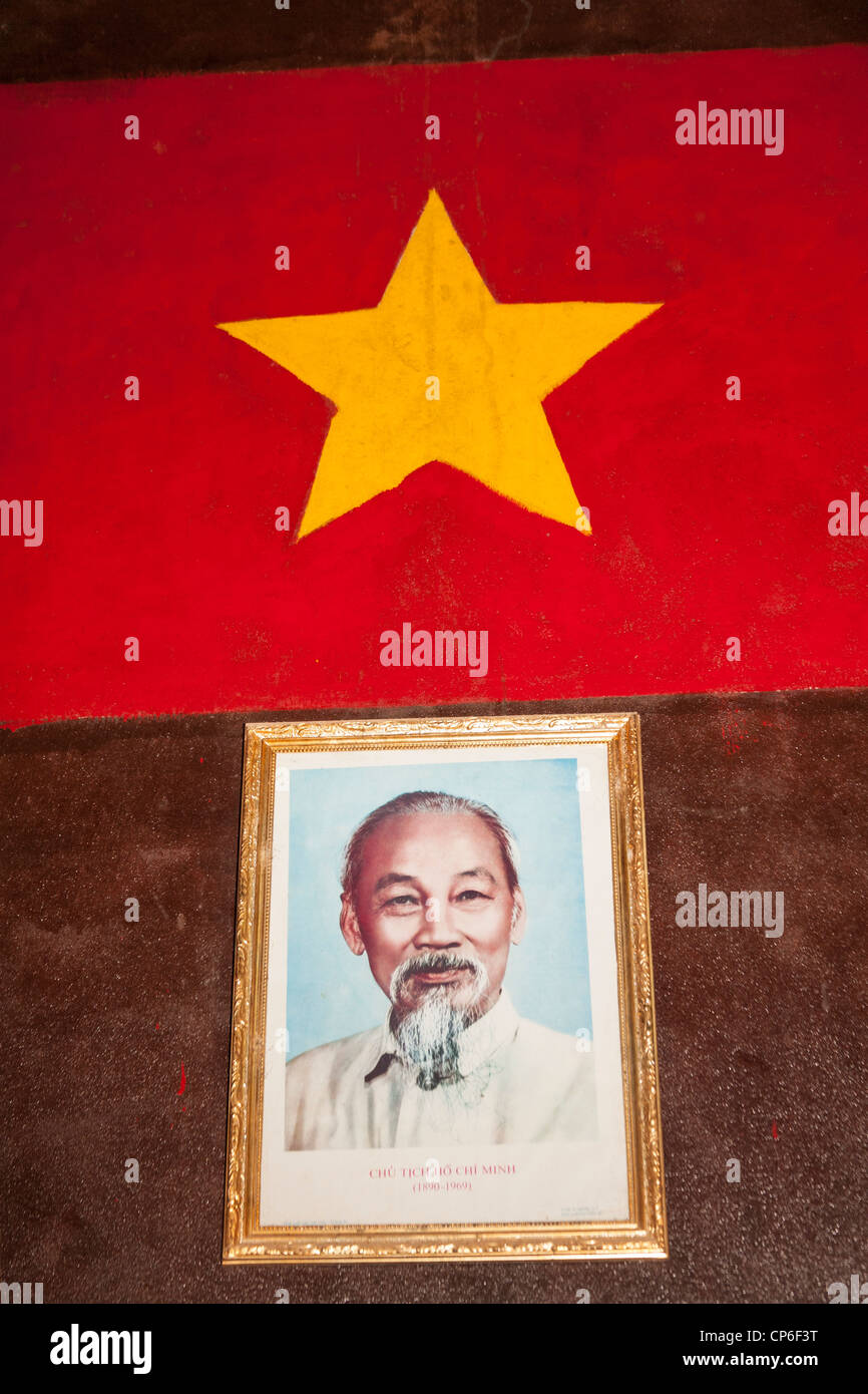 Ho Chi Minh portrait beneath Vietnamese flag, Ben Dinh, Cu Chi, near Ho Chi Minh City, (Saigon), Vietnam Stock Photo