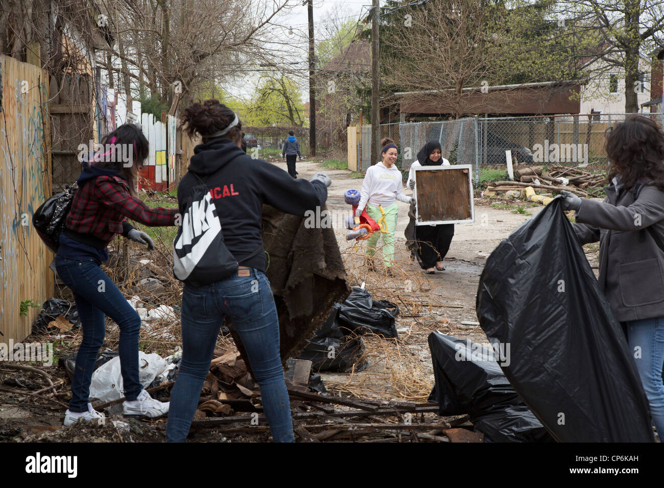 Detroit, Michigan - High school and college student volunteers clean trash from an alley. Stock Photo