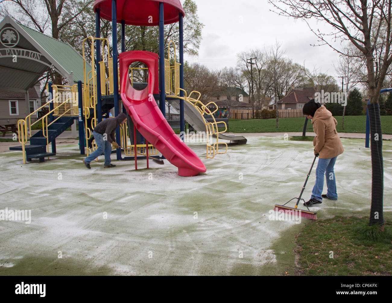 Detroit, Michigan - High school and college volunteers clean a playground. Stock Photo